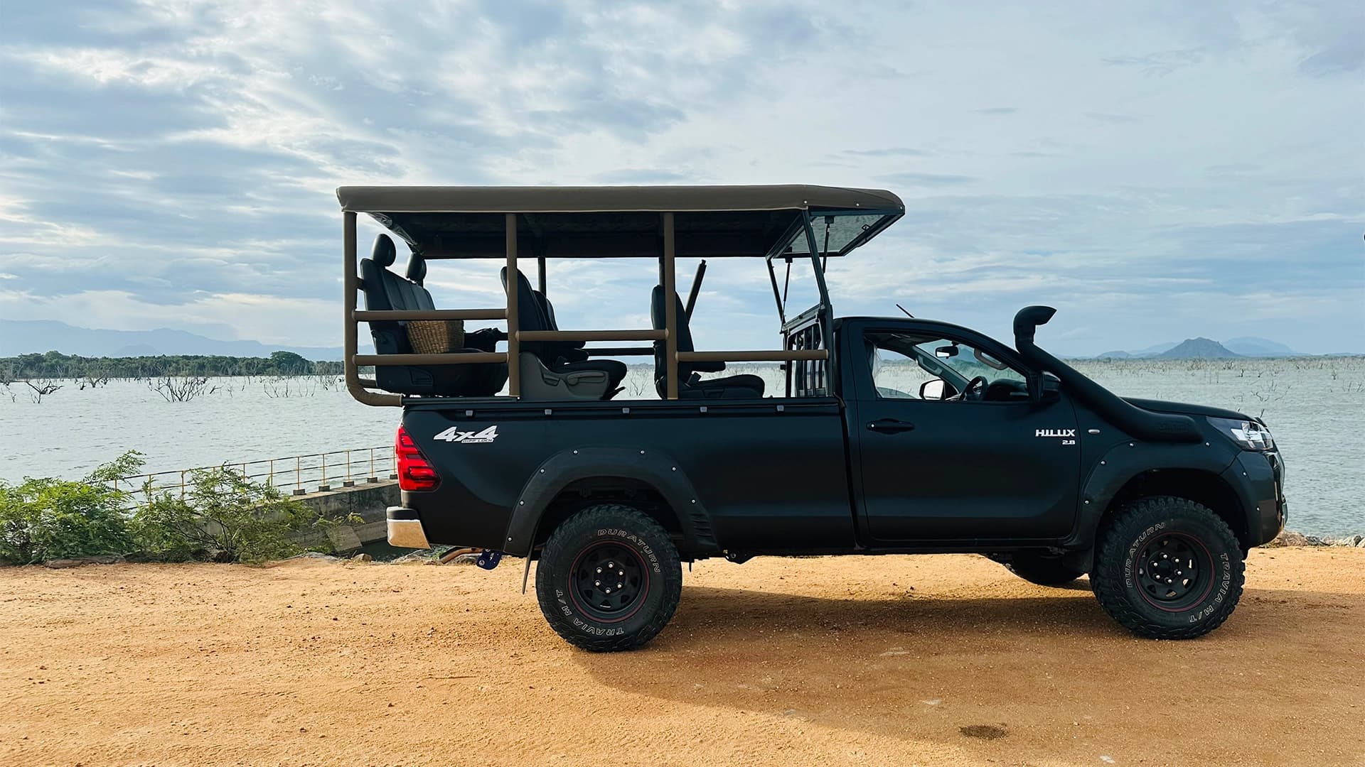 Safari vehicle set up as basecamp at night